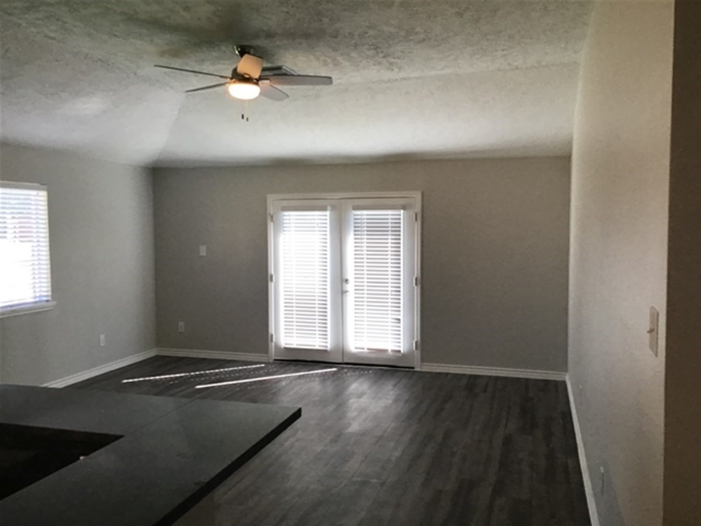 5026 Chase Stone Drive Bacliff, TX 77518 - Photo 4 of 18 an empty room with wooden floor and fan