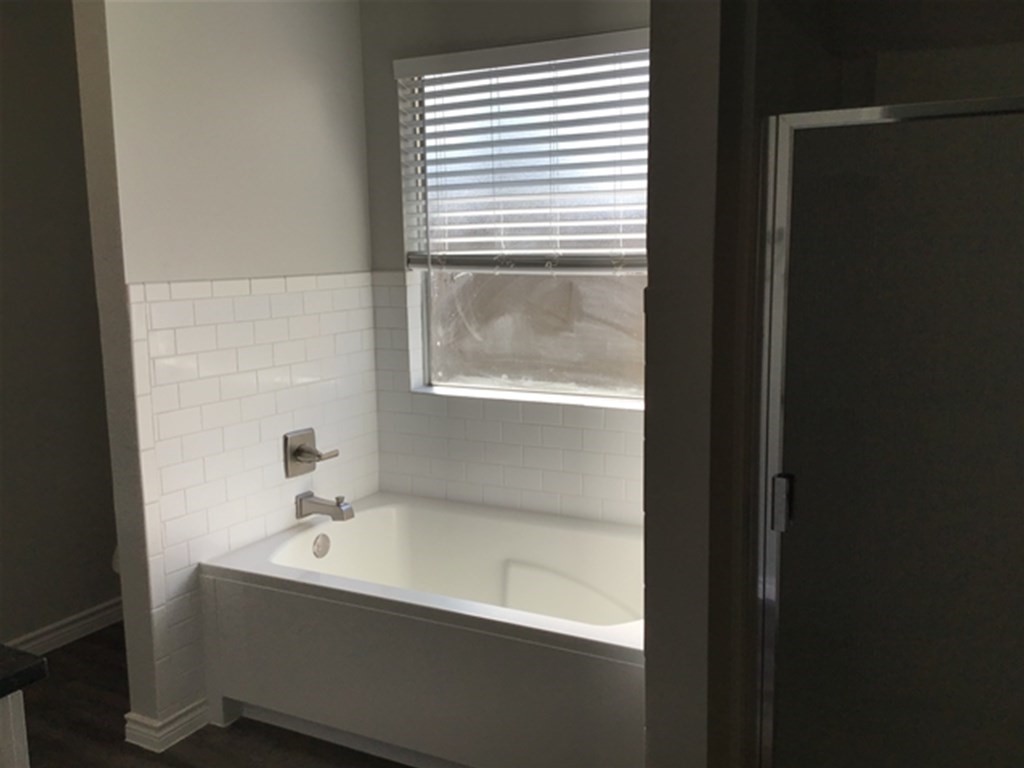 5026 Chase Stone Drive Bacliff, TX 77518 - Photo 7 of 18 a bathroom with a bathtub and a sink