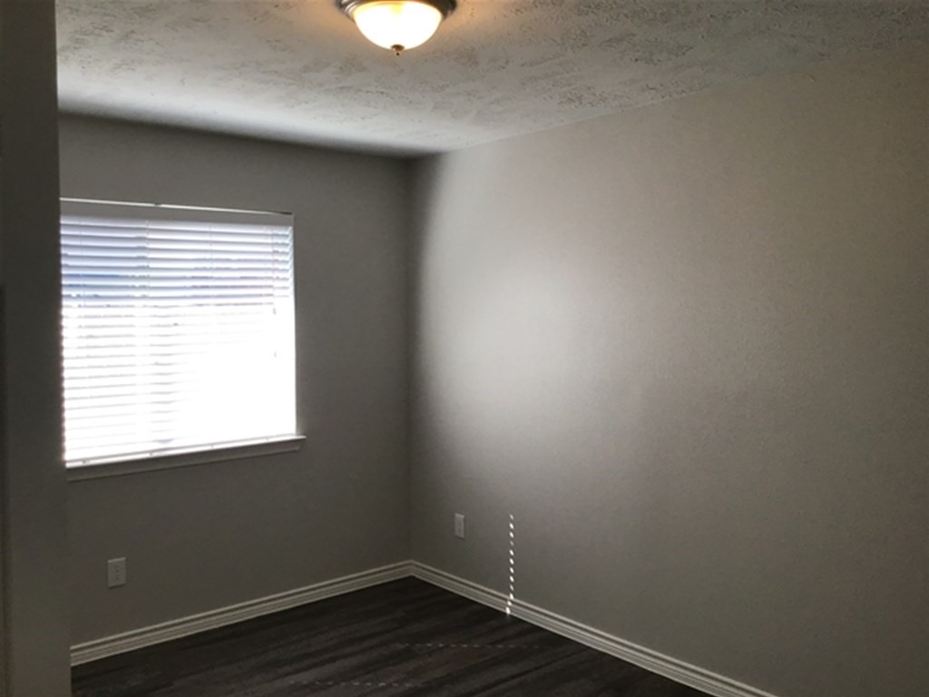 5026 Chase Stone Drive Bacliff, TX 77518 - Photo 9 of 18 an empty room with wooden floor and a window