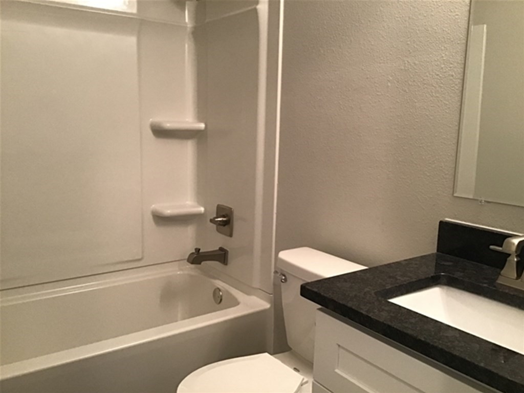 5026 Chase Stone Drive Bacliff, TX 77518 - Photo 10 of 18 a bathroom with a granite countertop sink and a bathtub