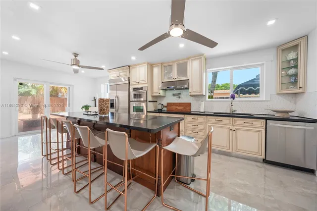 a kitchen with stainless steel appliances granite countertop lots of counter top space
