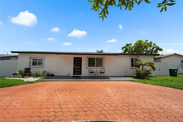 a front view of a house with a yard and a garage