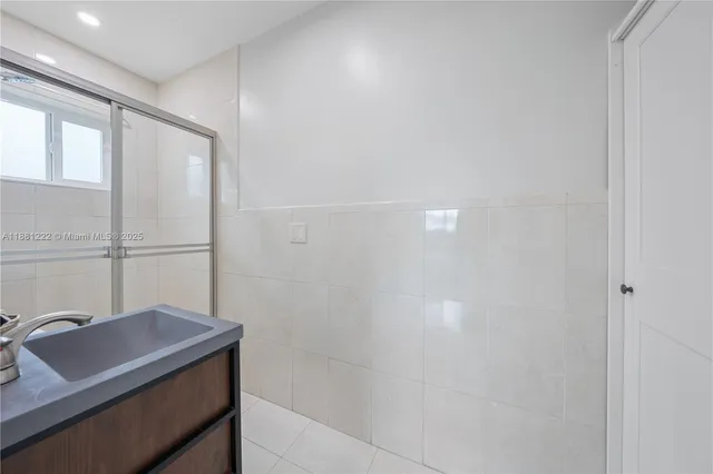 a bathroom with a granite countertop sink a toilet and a mirror