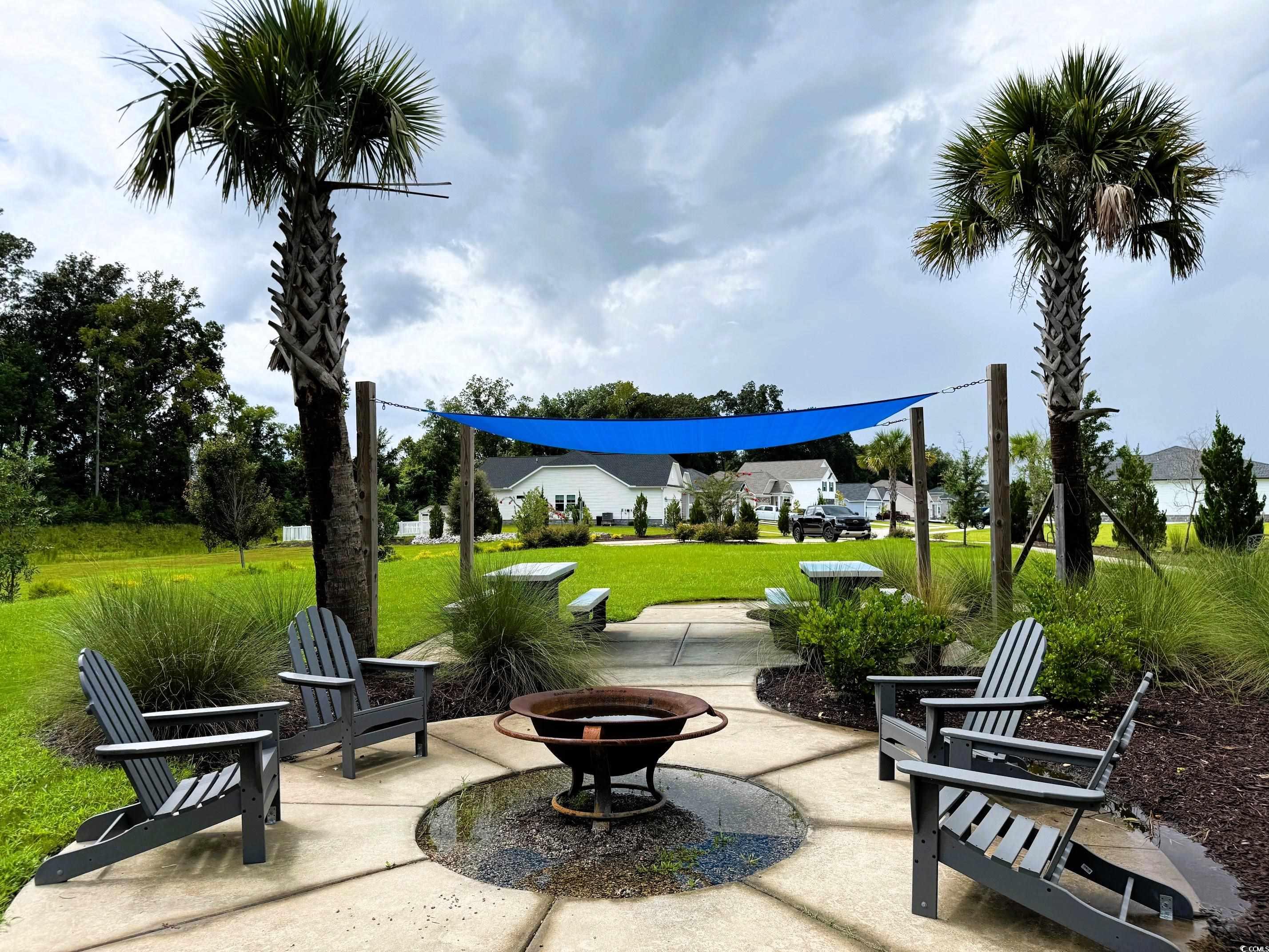 586 Honeyhill Loop Conway, SC 29526 - Photo 11 of 31 View of the community's amenity area with a yard, a fire pit, and a patio