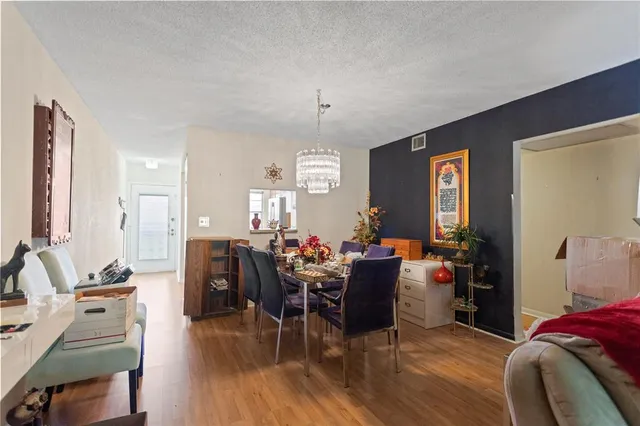 a view of a dining room with furniture and chandelier