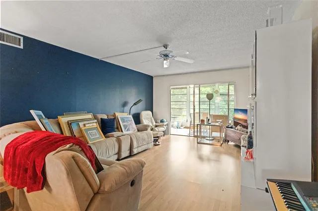 a living room with furniture fireplace and a large window