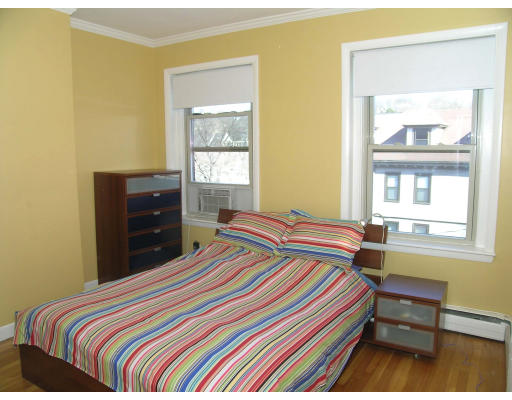15 University Road, Unit 44 Brookline, MA 02445 - Photo 1 of 12 a bedroom with a bed and a window