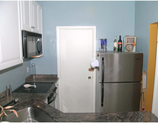 15 University Road, Unit 44 Brookline, MA 02445 - Photo 7 of 12 a white refrigerator freezer sitting inside of a kitchen