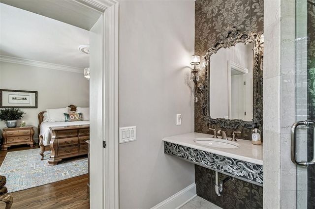 a spacious bathroom with a double vanity sink a mirror and a bathtub