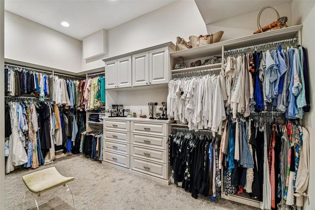 a living room with furniture kitchen view and a chandelier