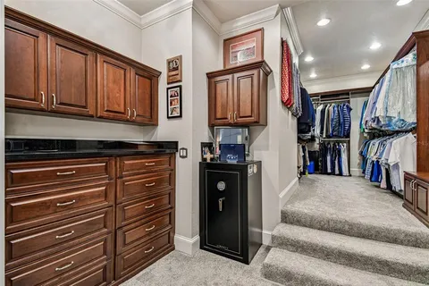 a kitchen with a sink counter top space stainless steel appliances and a large window