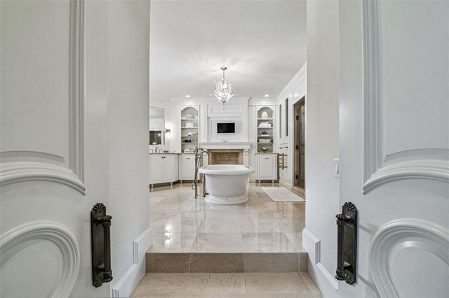 a kitchen with stainless steel appliances granite countertop a sink a stove and a wooden floors