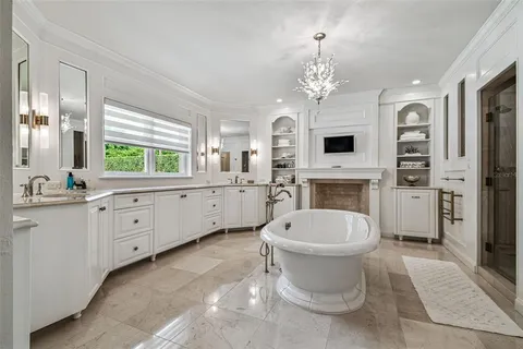 a kitchen with stainless steel appliances granite countertop a stove a refrigerator a sink a dining table and chairs with wooden floor