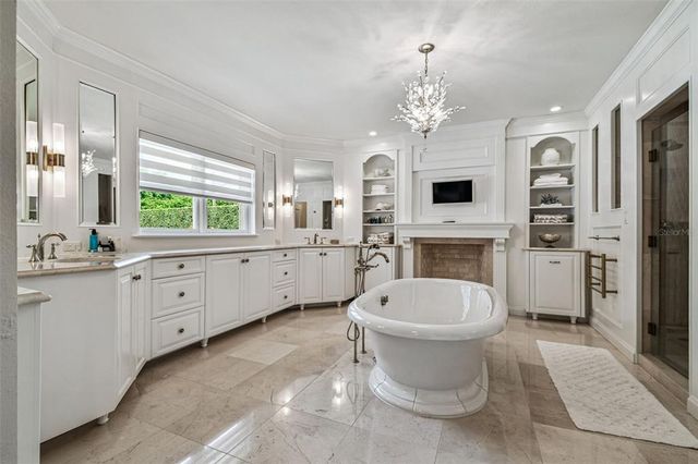 a kitchen with stainless steel appliances granite countertop a stove a refrigerator a sink a dining table and chairs with wooden floor