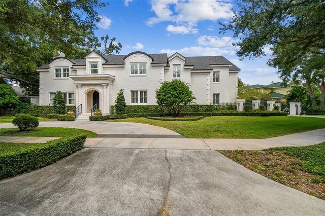 a view of white house with a yard