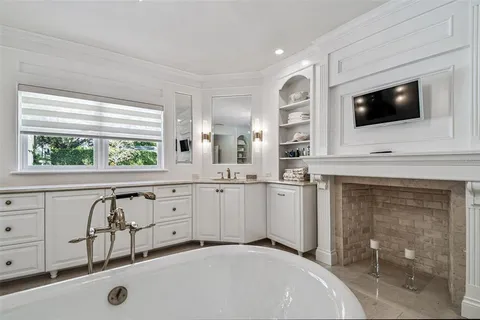 a kitchen with stainless steel appliances granite countertop a sink a stove and a wooden floors