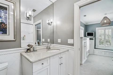 an aerial view of a house with a yard and a large tree