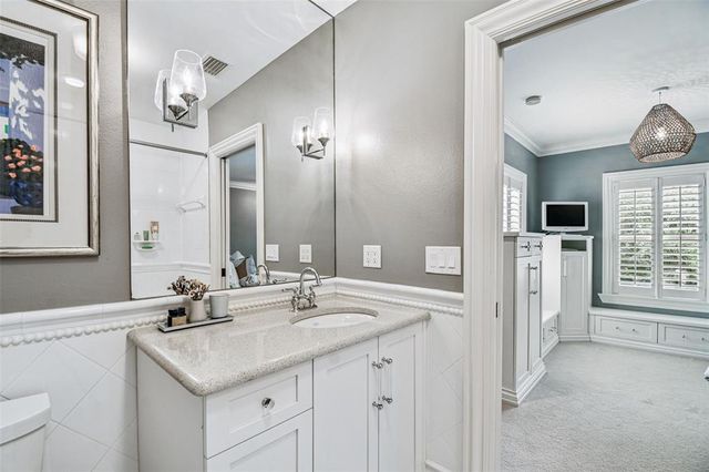 an aerial view of a house with a yard and a large tree