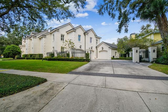 a dining room with furniture a chandelier and wooden floor
