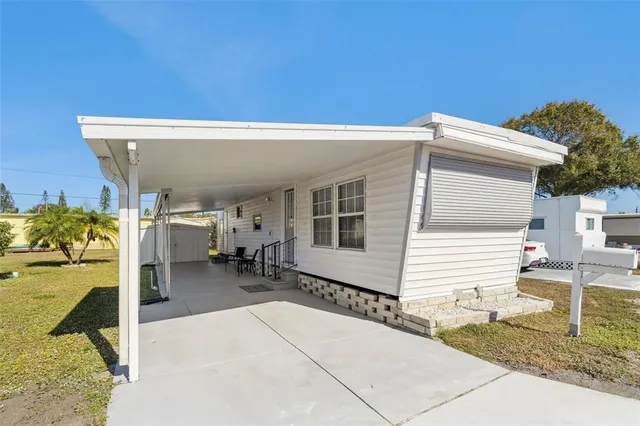a view of a patio with table and chairs and a barbeque