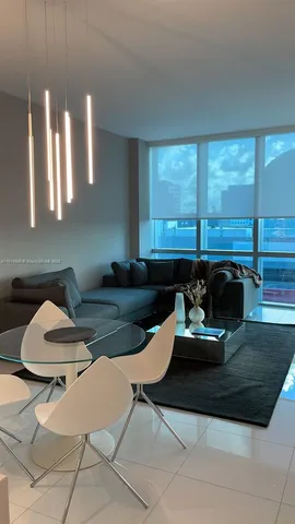 a kitchen with a table chairs and a sink