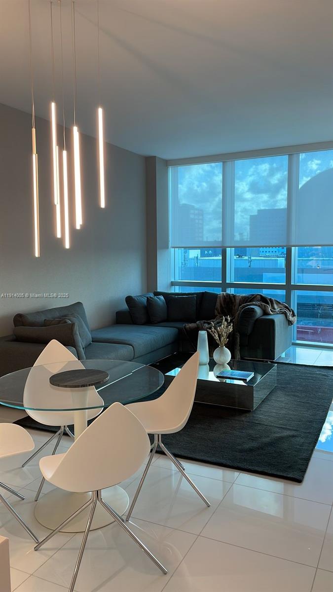 a kitchen with a table chairs and a sink
