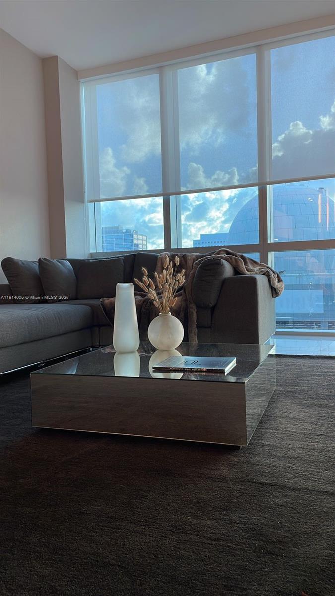 851 Northeast 1st Avenue, Unit 1006 Miami, FL 33132 - Photo 2 of 9 a living room with furniture and a large window