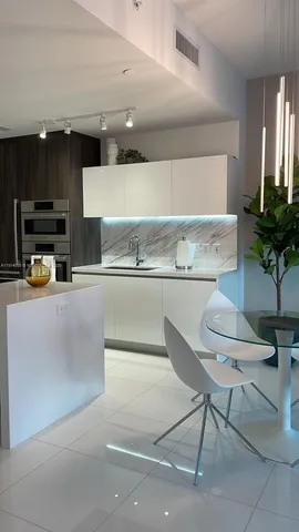 a kitchen with stainless steel appliances kitchen island granite countertop a sink and cabinets