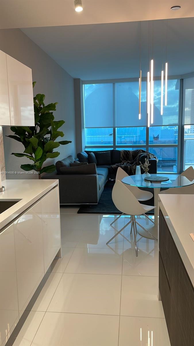 851 Northeast 1st Avenue, Unit 1006 Miami, FL 33132 - Photo 5 of 9 a kitchen with a sink and a stove