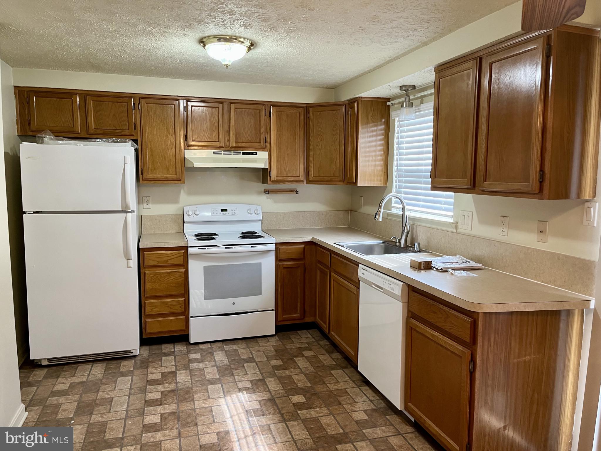 1463 Mobley Court Frederick, MD 21701 - Photo 15 of 32 a kitchen with a sink stove and refrigerator