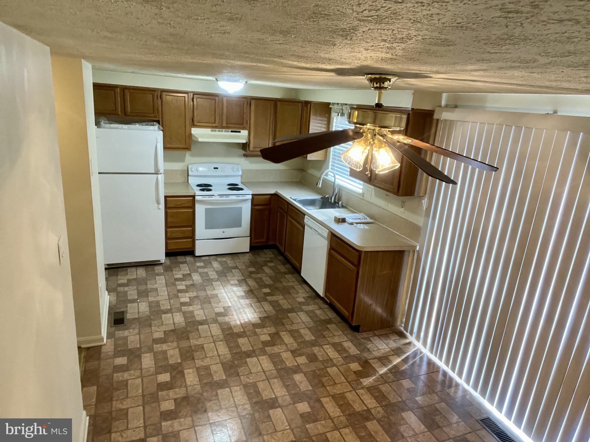 1463 Mobley Court Frederick, MD 21701 - Photo 16 of 32 a kitchen with stainless steel appliances granite countertop a stove a sink and a refrigerator