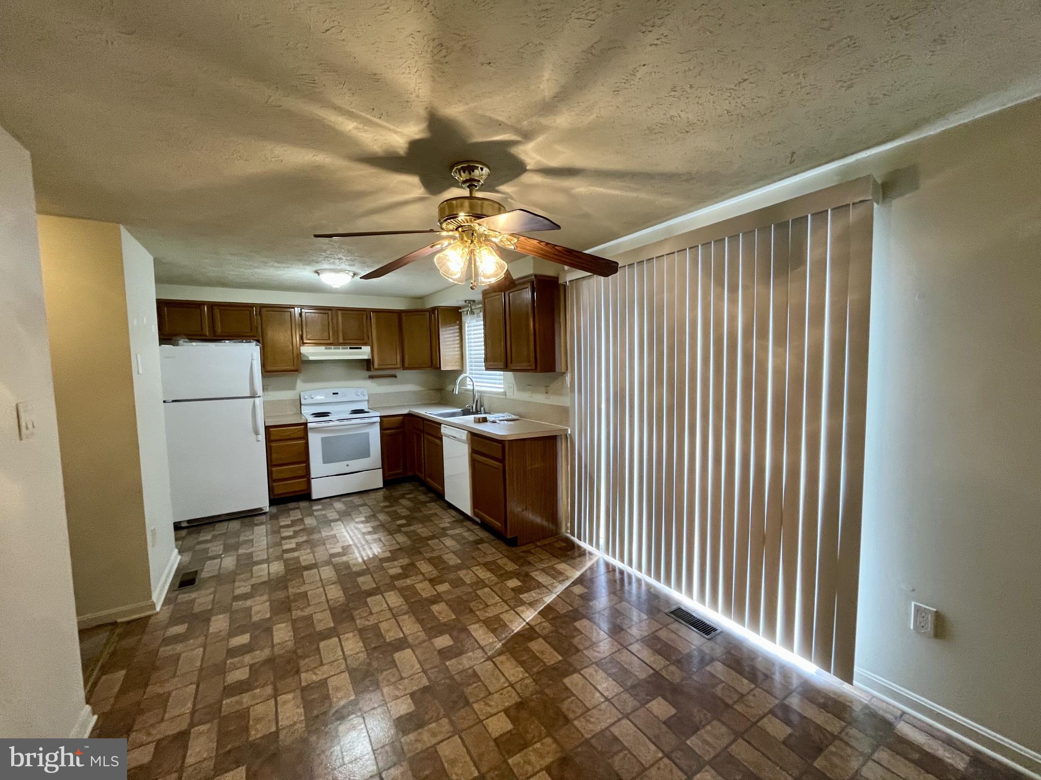 1463 Mobley Court Frederick, MD 21701 - Photo 17 of 32 a kitchen with a refrigerator a sink and a dishwasher