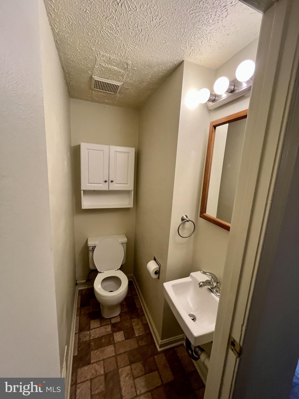 1463 Mobley Court Frederick, MD 21701 - Photo 19 of 32 a bathroom with a toilet a sink and mirror
