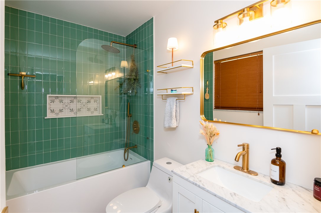 4102 Ridgetop Drive Bellbrook, OH 45305 - Photo 19 of 33 This bathroom features a sleek design with modern fixtures and a vibrant tiled shower.
