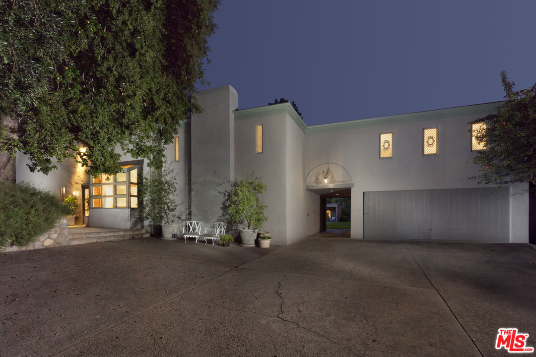 a view of a house with a yard and a garage