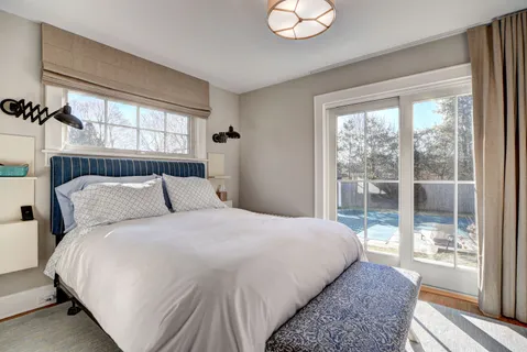 a bedroom with a large bed and a large window