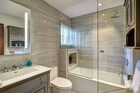 a bathroom with a sink a toilet and shower