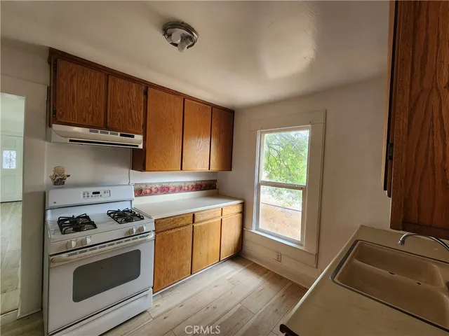 a kitchen with stainless steel appliances granite countertop a stove and a refrigerator