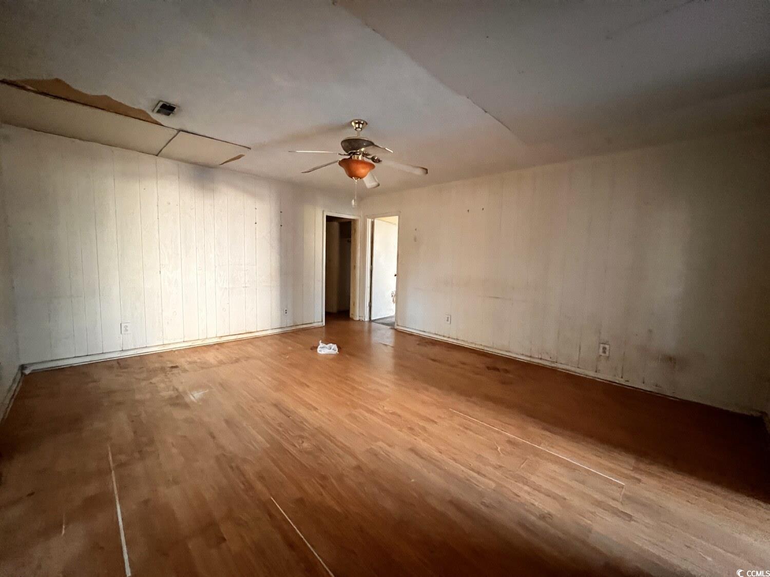 33 Plantation Road Myrtle Beach, SC 29588 - Photo 12 of 22 Unfurnished room featuring wood finished floors and a ceiling fan