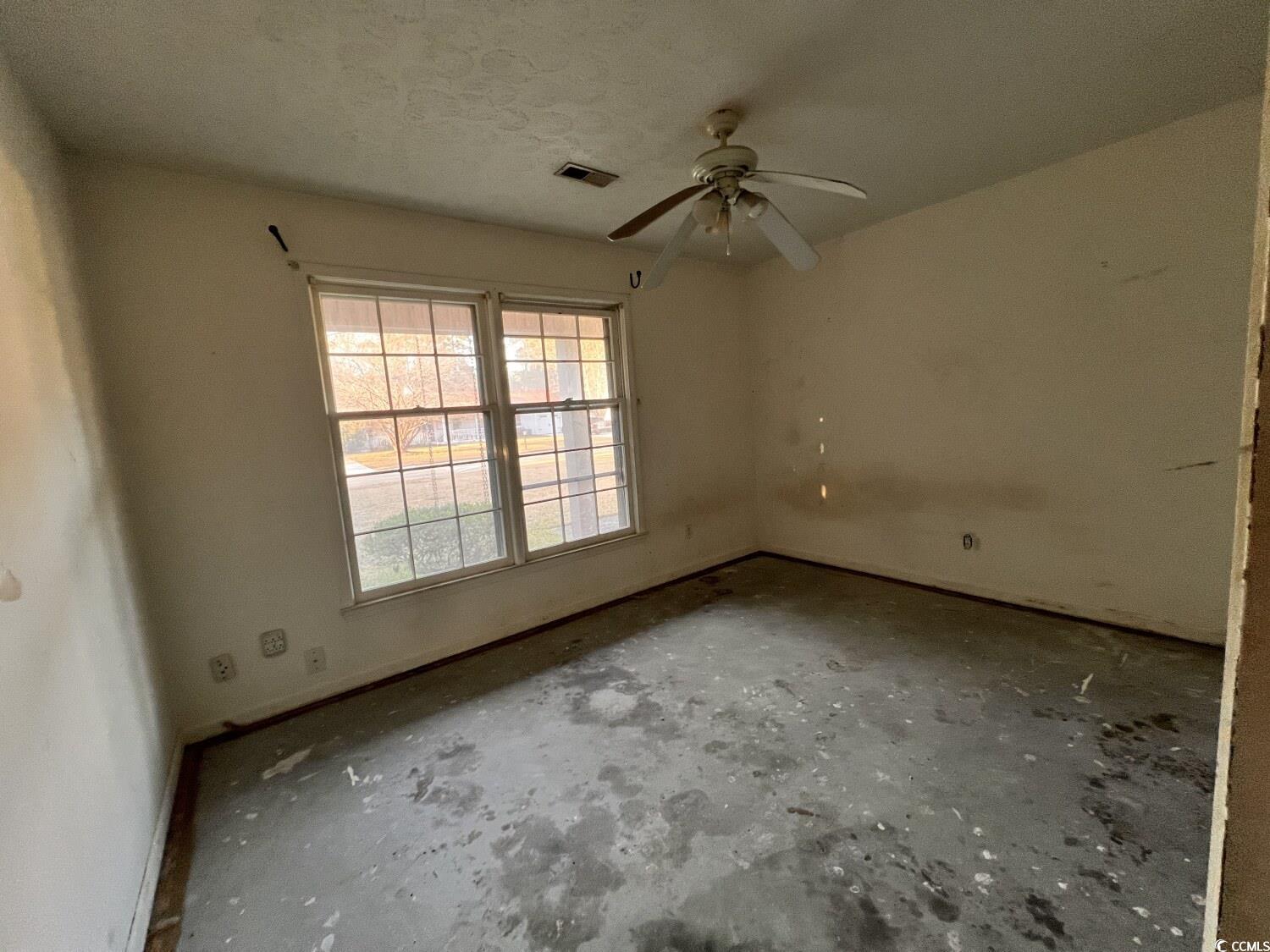 33 Plantation Road Myrtle Beach, SC 29588 - Photo 14 of 22 Spare room featuring a ceiling fan, a textured ceiling, and unfinished concrete flooring