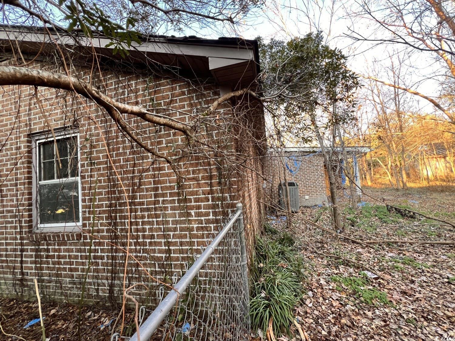 33 Plantation Road Myrtle Beach, SC 29588 - Photo 21 of 22 View of side of property featuring brick siding