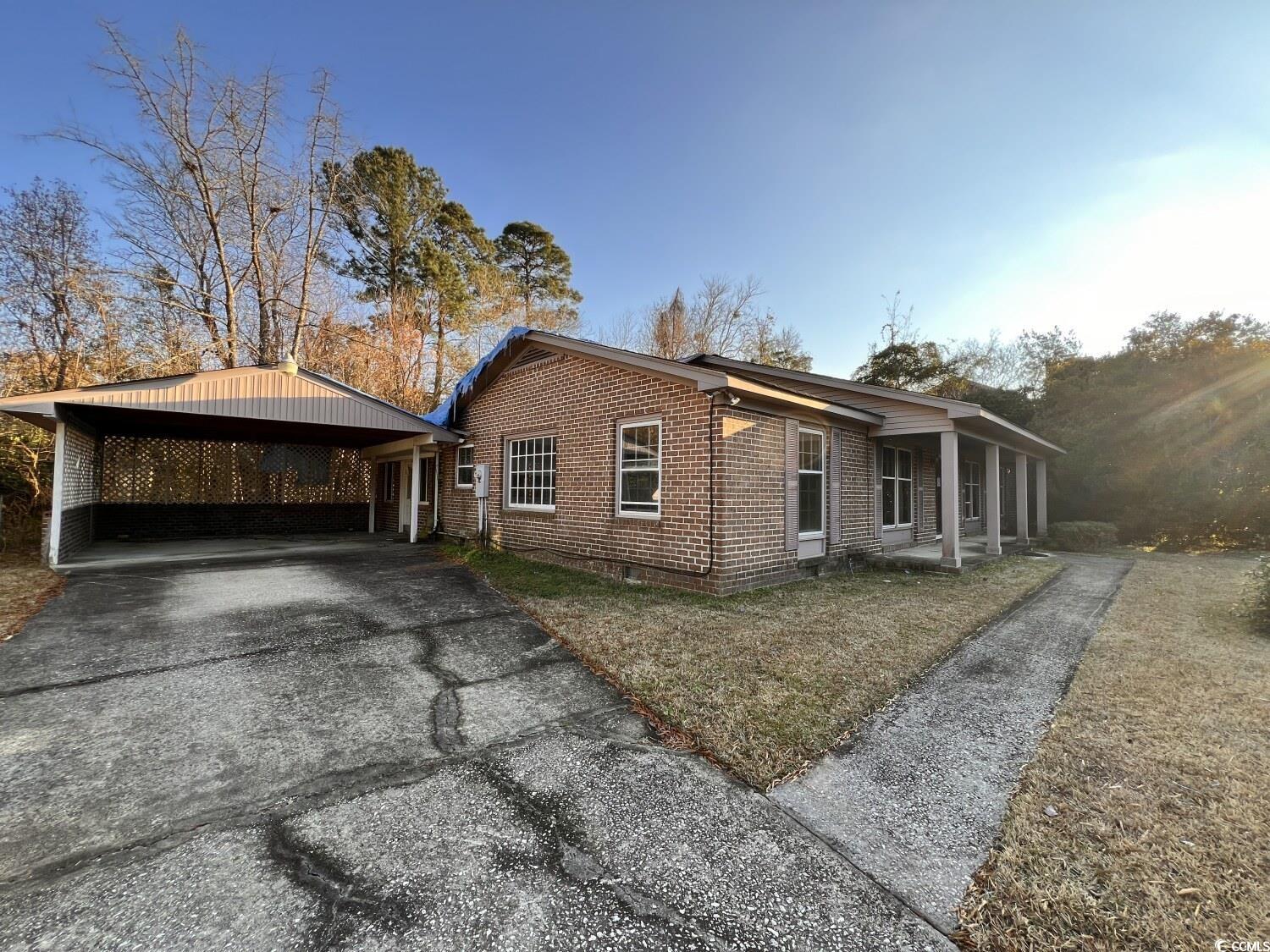 33 Plantation Road Myrtle Beach, SC 29588 - Photo 22 of 22 View of side of property featuring asphalt driveway and brick siding