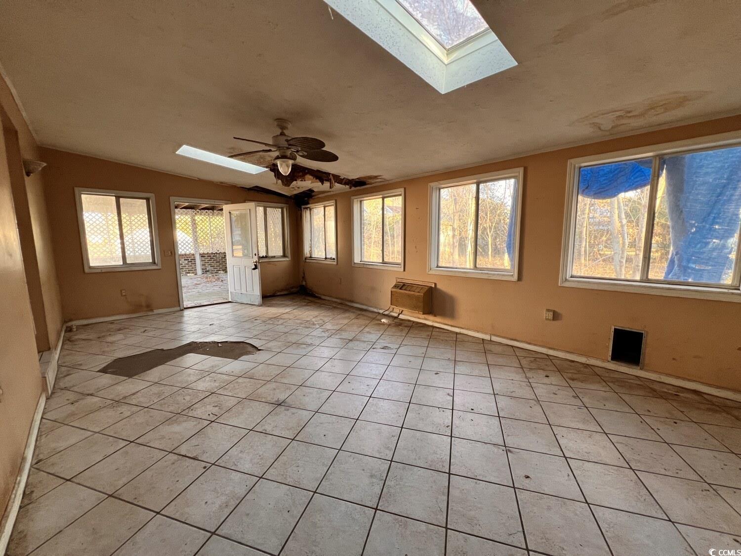 33 Plantation Road Myrtle Beach, SC 29588 - Photo 3 of 22 Unfurnished sunroom with a skylight and heating unit
