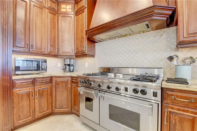 a white stove top oven sitting inside of a kitchen