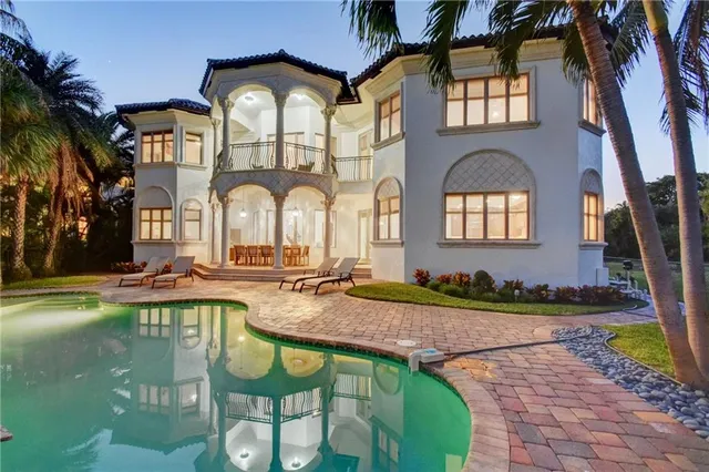 a front view of a house with swimming pool having outdoor seating