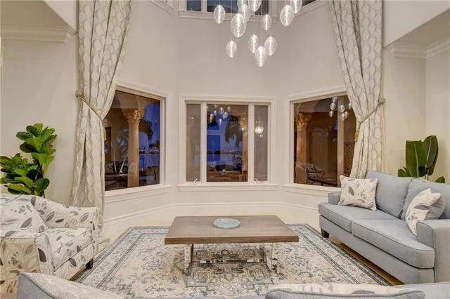 a view of a hallway with windows and chandelier