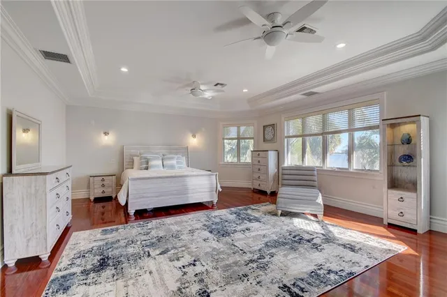 a spacious bedroom with a large bed and a flat screen tv