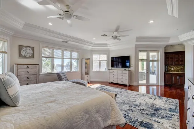 a bedroom with a bed window and a flat screen tv