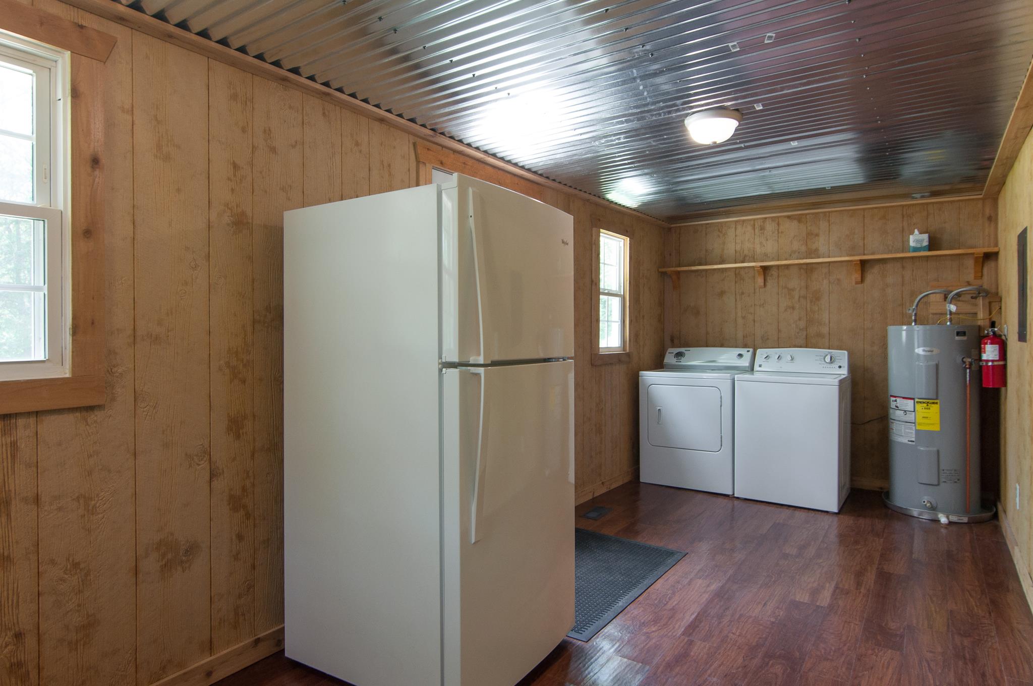 4455 Cato Road Nashville, TN 37218 - Photo 18 of 30 The kitchen is at the rear of the house and has a utility area. Water heater is newer and the washer, dryer and fridge remain.