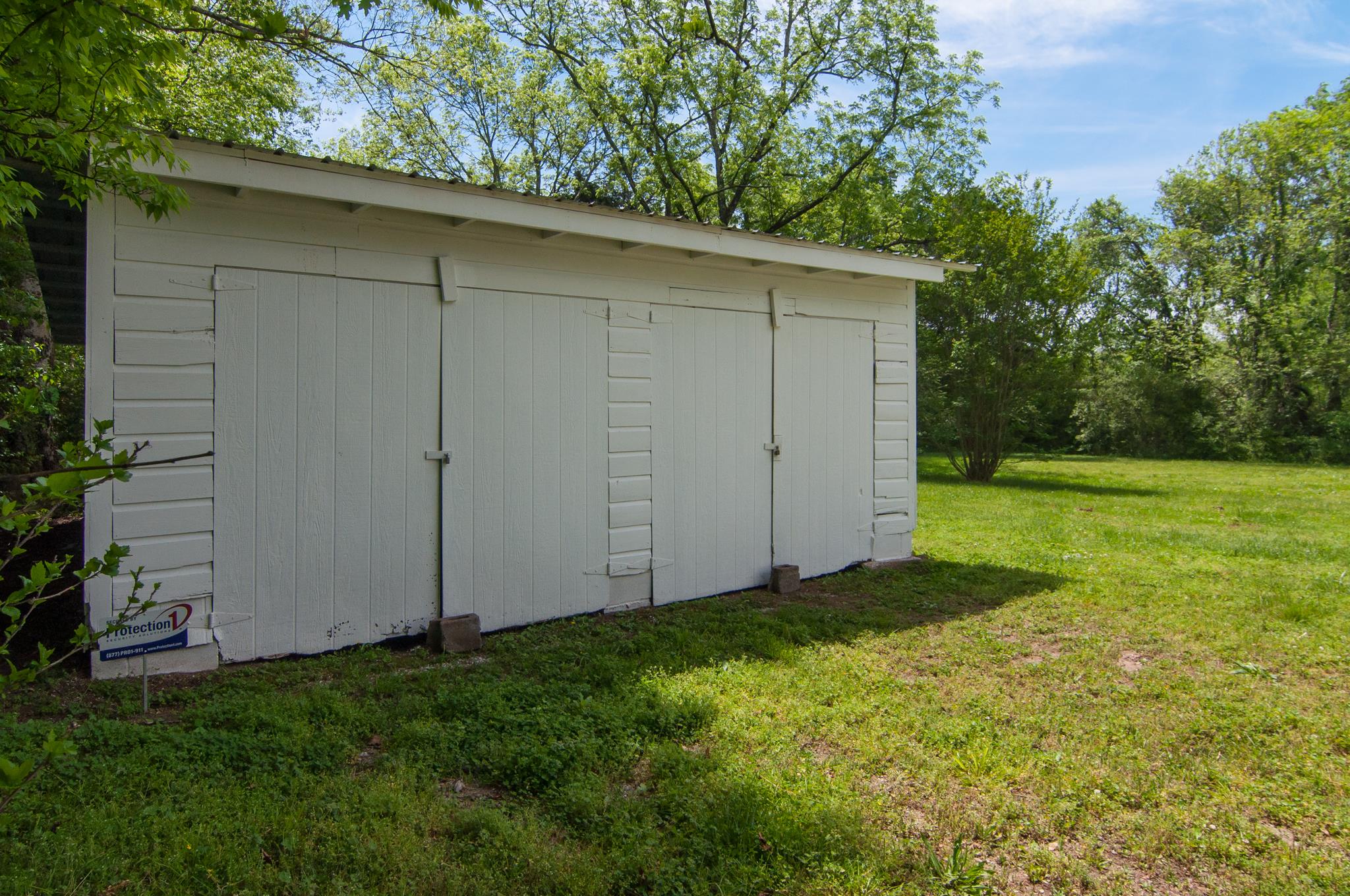 4455 Cato Road Nashville, TN 37218 - Photo 28 of 30 The detached garage has been painted and has a metal roof. There is an old cistern behind the garage.